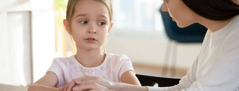 HeadShotUnhappySmallChildGirlSittingAtTableWith