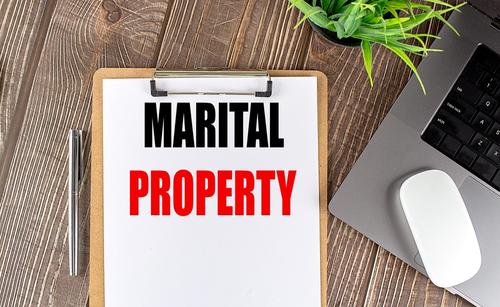 MaritalPropertyTextOnAClipboardPaperWithLaptopMouse