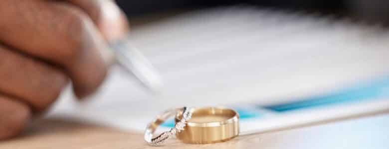 DivorceRingsAndSignatureOnPaperworkForALawyerRegister
